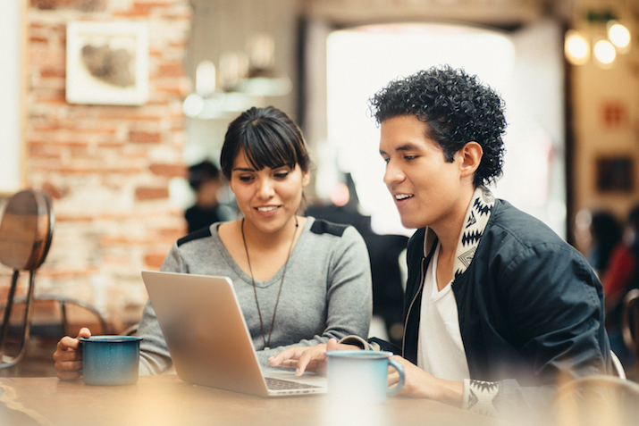 Developers collaborating on open-source telemetry code in the New Relic Experimental GitHub repository