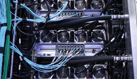 Rows of GPU servers with liquid cooling pipes inside a modern data center