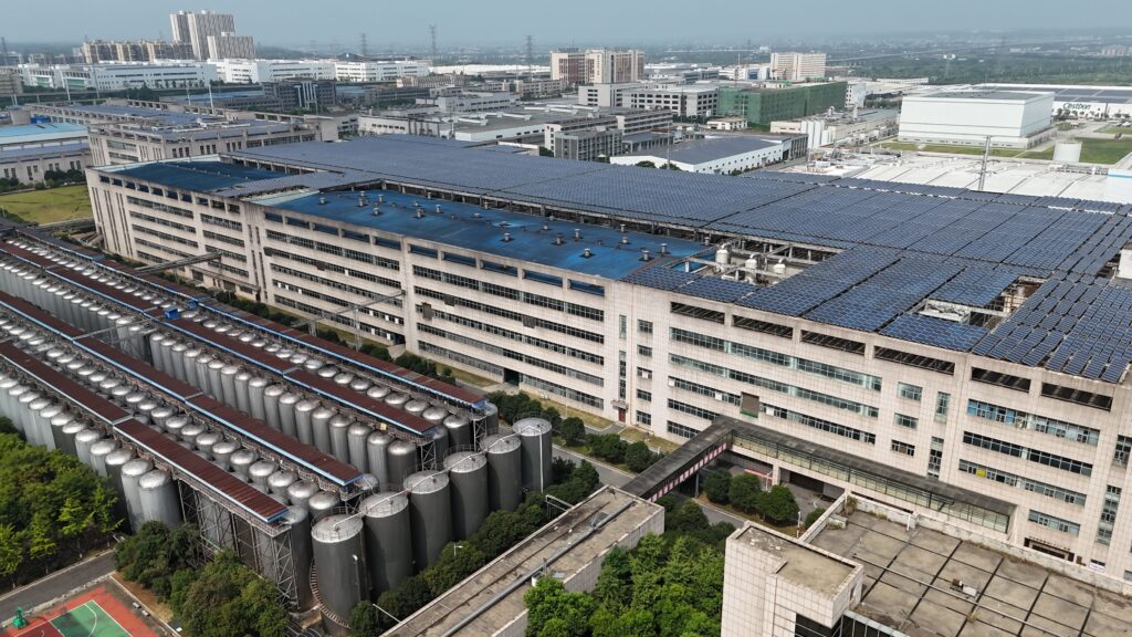 Aerial view of a large AI-ready data center facility with cooling towers and modular server buildings