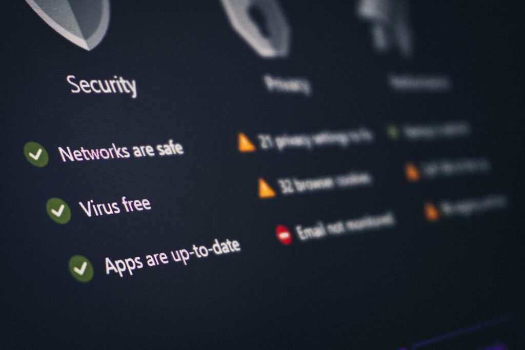 A developer monitors an AI agent dashboard showing security alerts on multiple screens in a dark server room